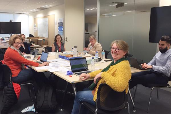 The PPE Review Group gathered around a large desk