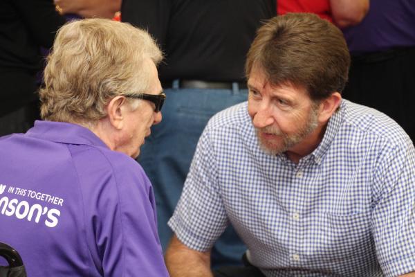 Vince Carroll is seated in conversation with a patient